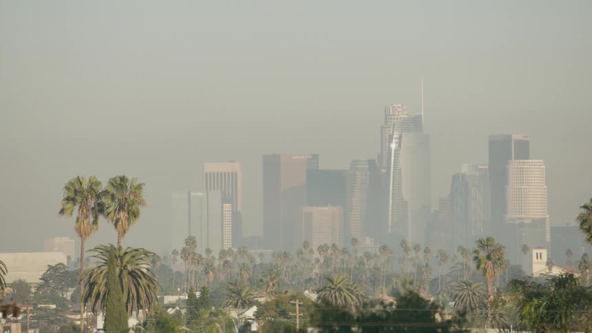 Big city skyline from a distant with high rise buildings in fog on the horizon