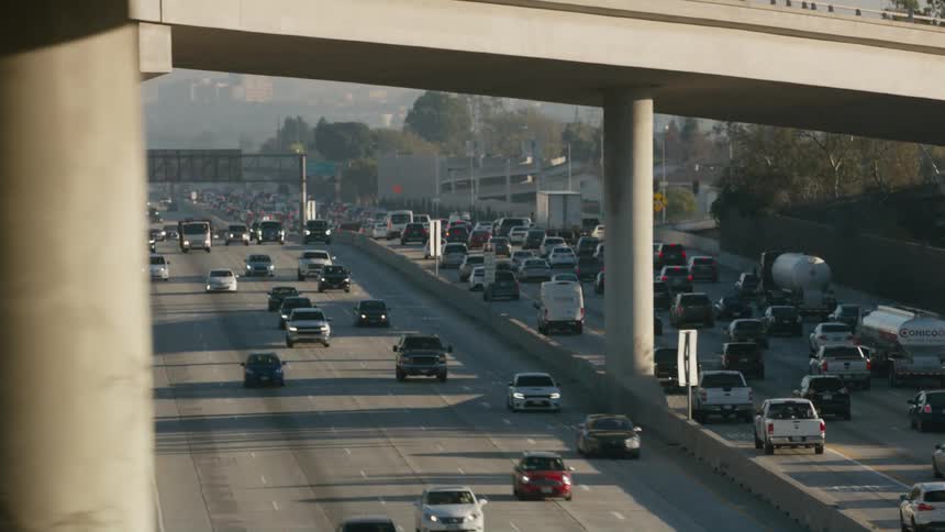 Traffic is at a standstill on a highway heading toward downtown