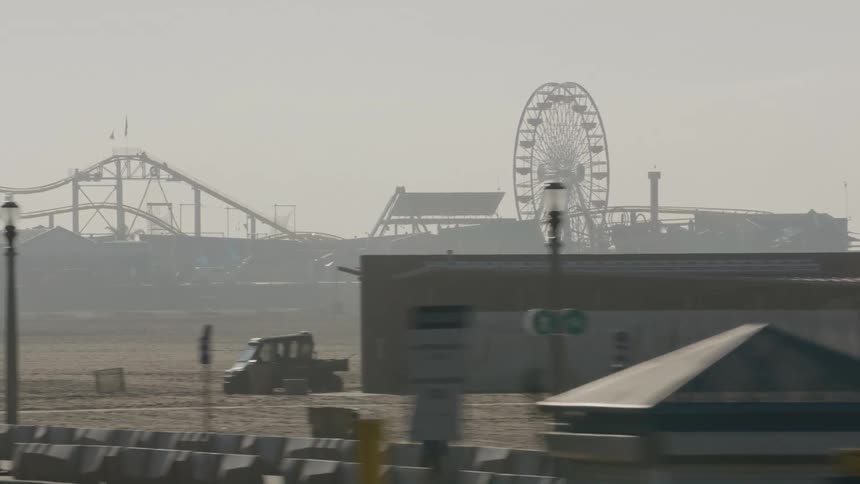 A view of a beach with a ferris wheel