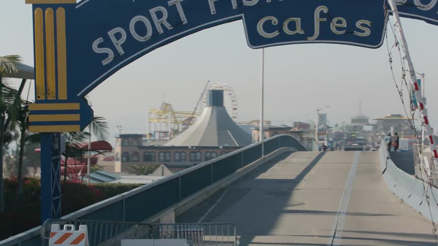 People move along road leading to amusement park and yacht harbor cafes