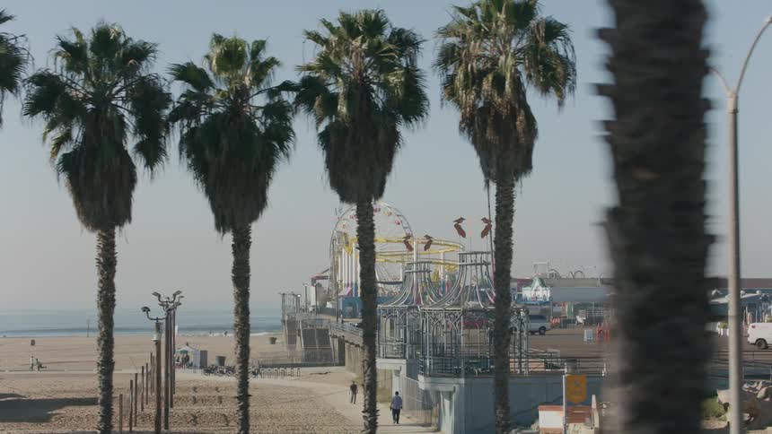 An amusement park on a beach on a sunny summer day