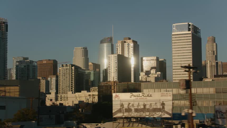 Reflective buildings in downtown tower block reflect the glaring sun