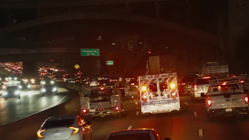 A view of traffic driving outdoors at night