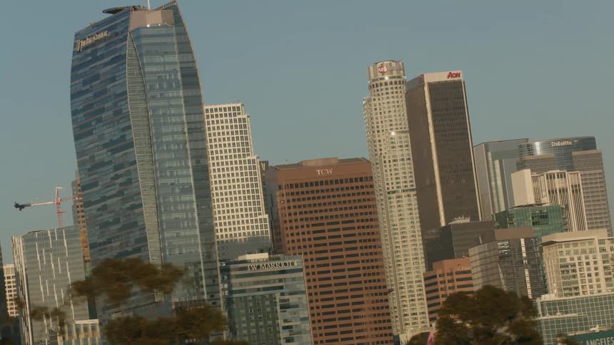 A tilting view of the city of Los Angeles with tall buildings rotating