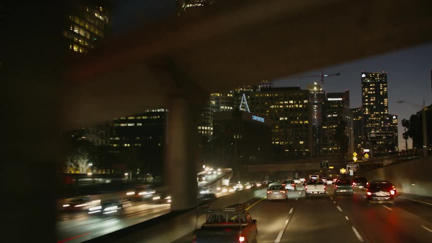 Traffic travels on the busy highway in the city at night
