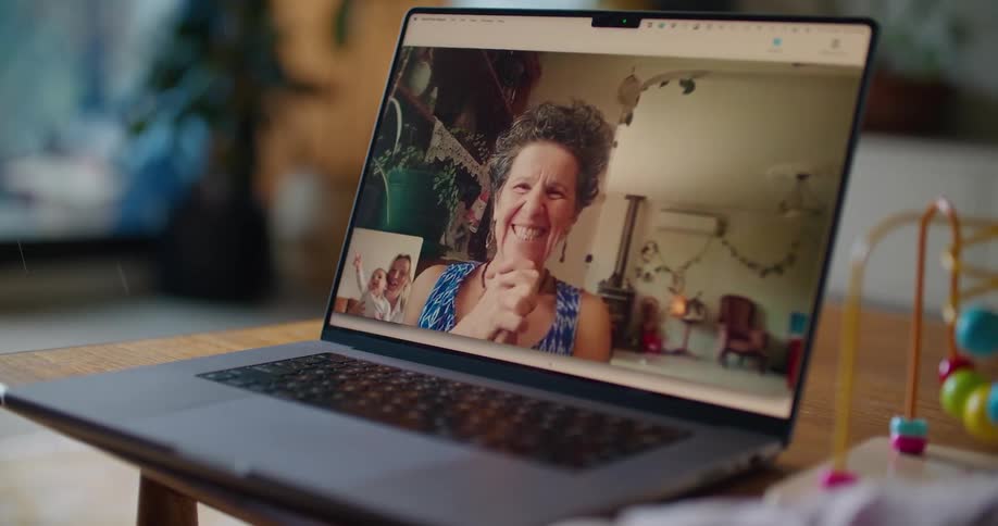 Someone is having a video conversation with a woman on a laptop computer
