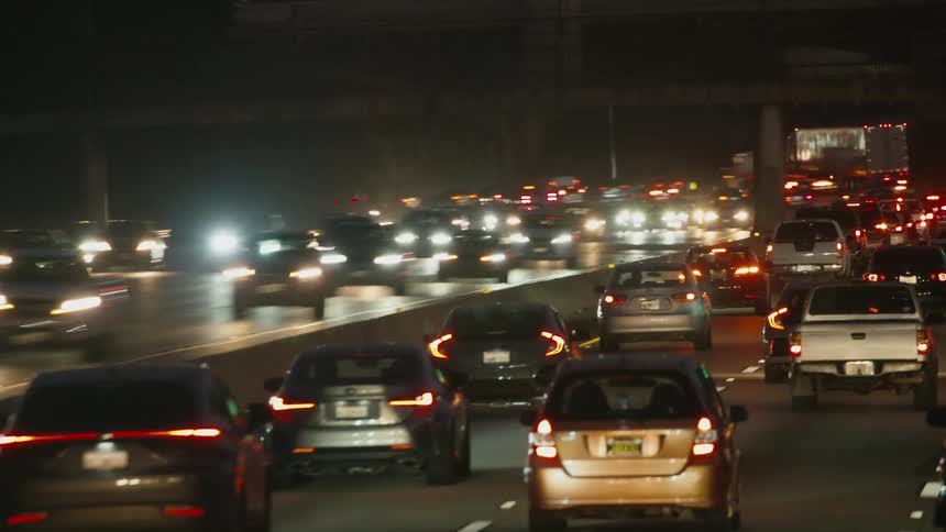 Time lapse of vehicles driving on a busy freeway at night