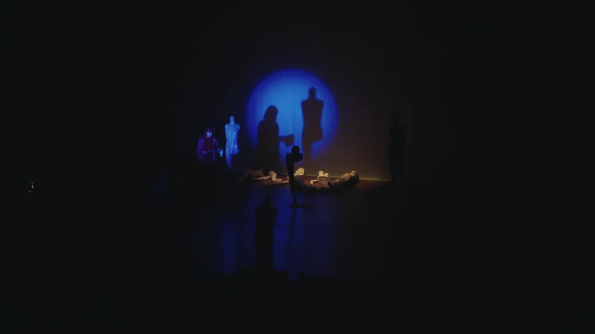 Two people are on stage for a performance