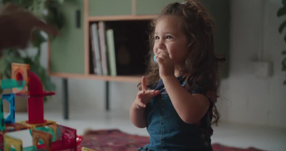 A child is playing with her toys