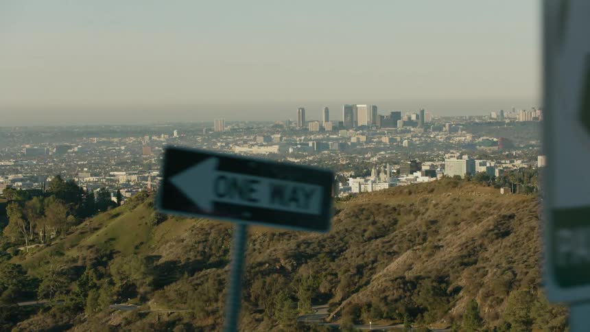 Aerial view of a city skyline at dusk is displayed