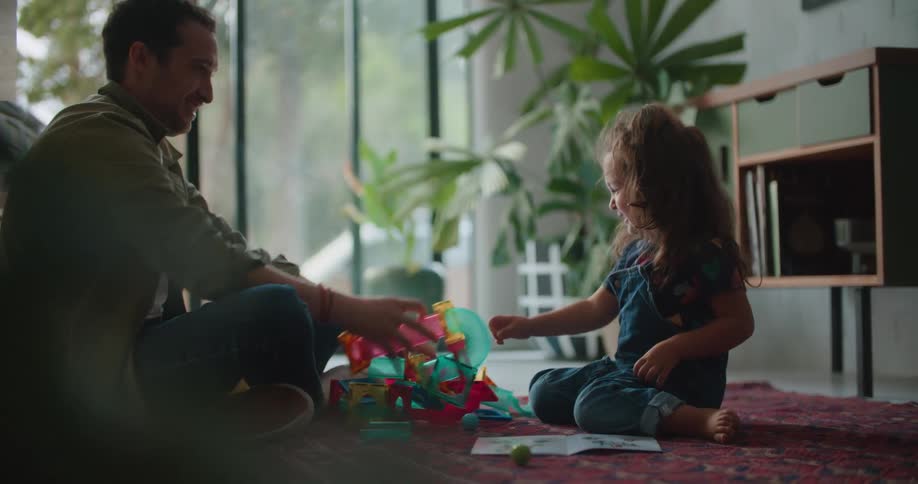 A father and daughter playing with toys