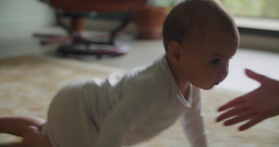 A baby crawls over to her mother