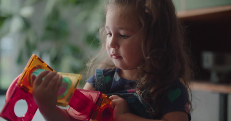 A child is playing with her toy