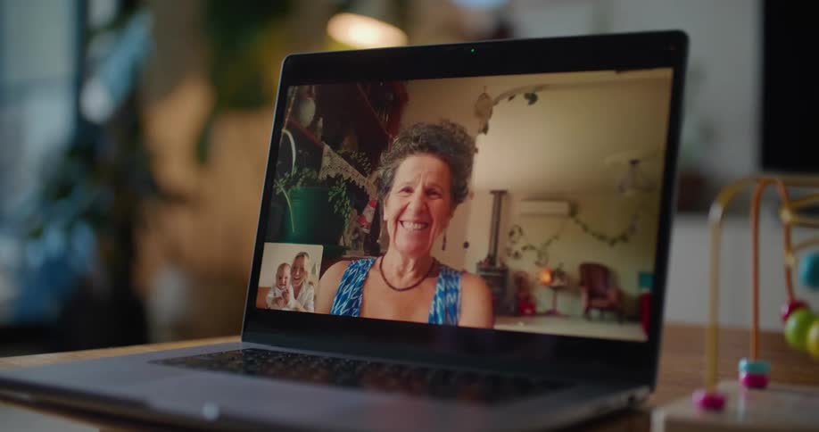 Video chat on a laptop screen between a mother and her baby and the babys grandmother