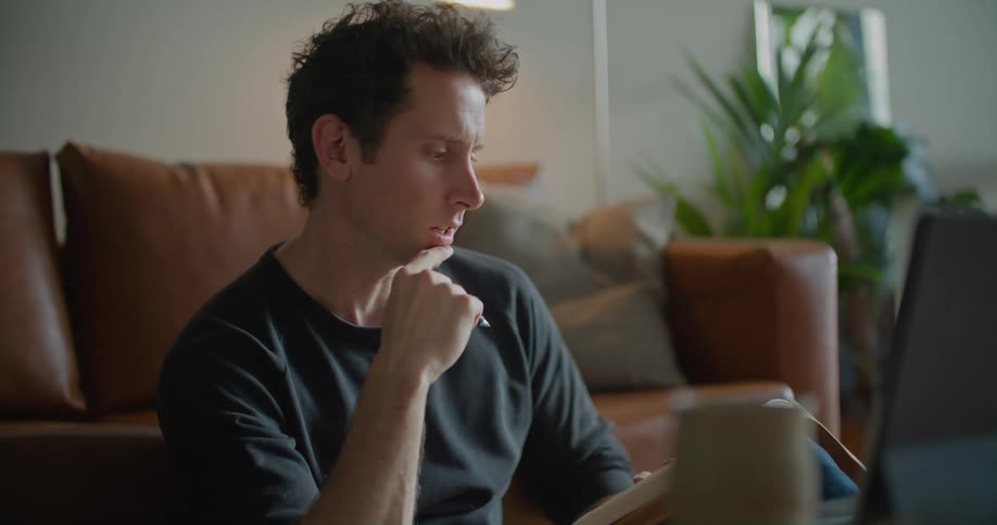 A man is video chatting via laptop indoors