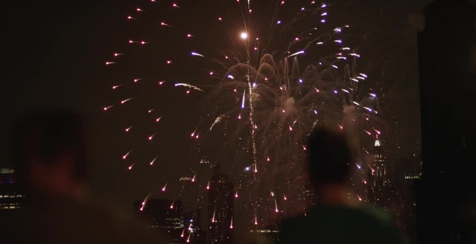 Blurry view of people watching fireworks comes into focus