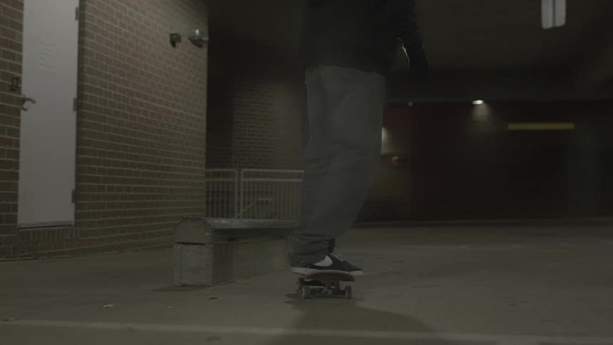 Person on a skateboard outside a brick building in the city