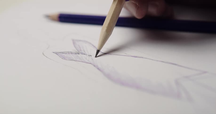 An artist is sketching with two different pencils