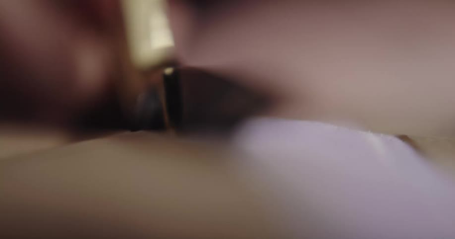 A person is cutting fabric indoors