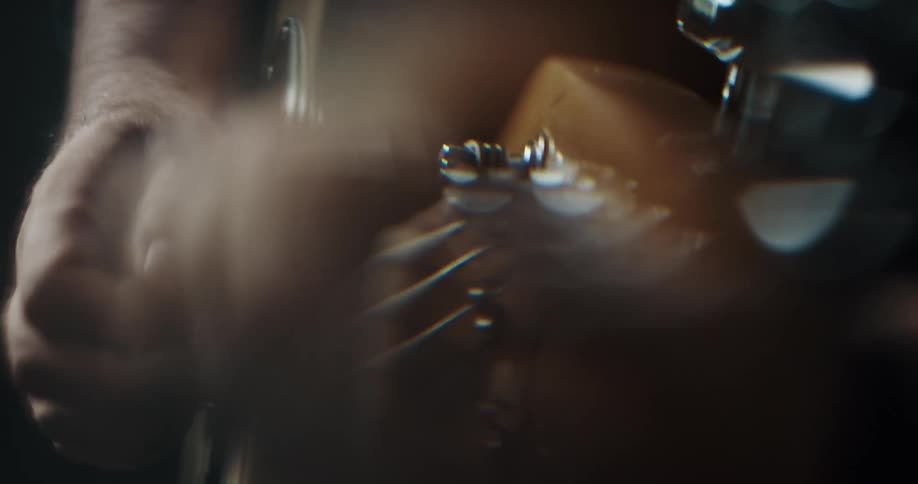 Close up of a man playing guitar