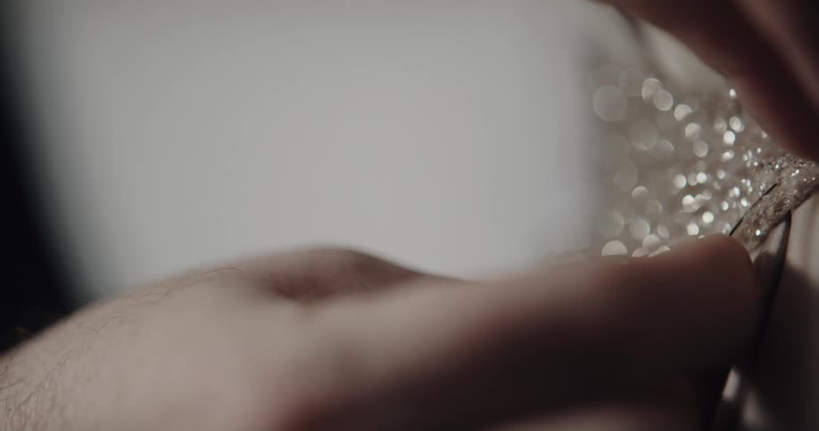 Person uses pins to tailor clothes