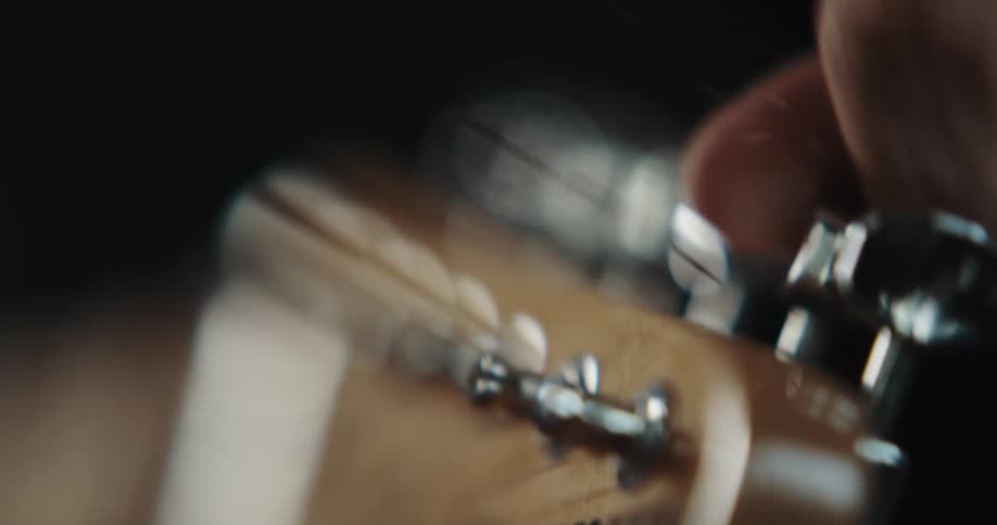 A person is adjusting the guitar