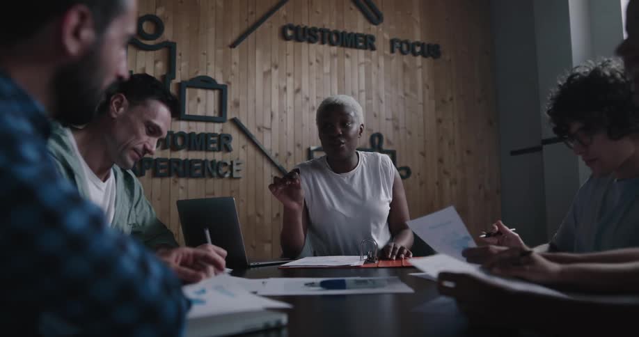 Supervisor talking to employees on a meeting room at the office