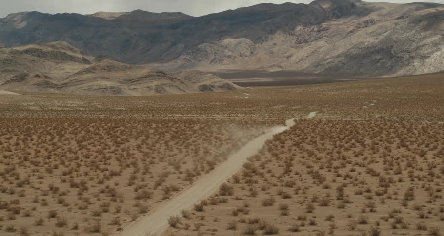 An aerial view of a dirt road in the desert