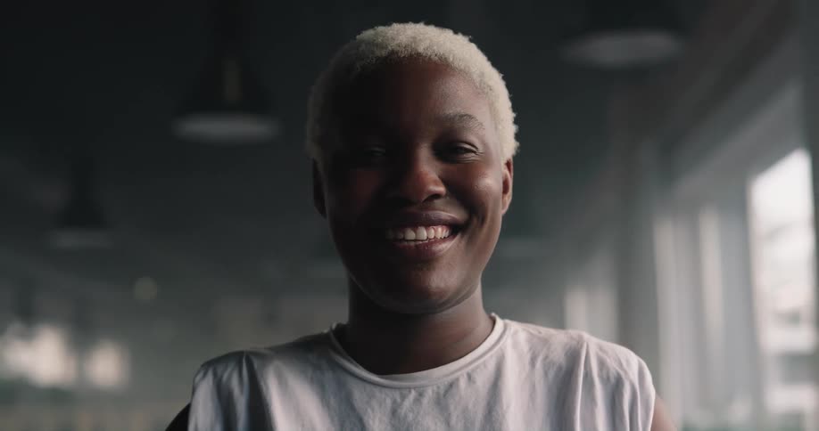 A woman with white hair is smiling