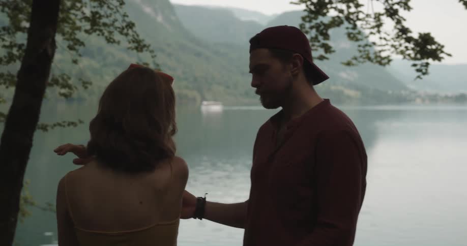 A man tries to comfort his girlfriend during a fight at the lake