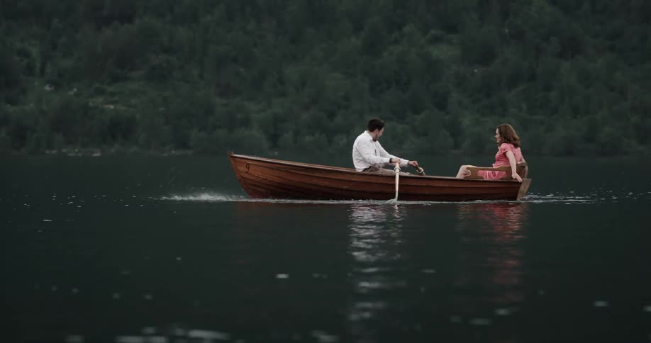 Two people are in a boat on the lake in spring