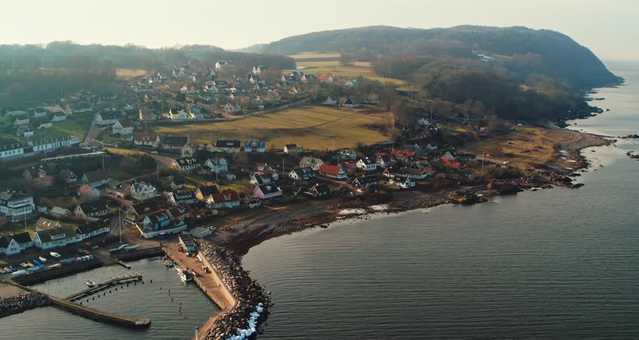The coastline of a town next to the ocean during the day