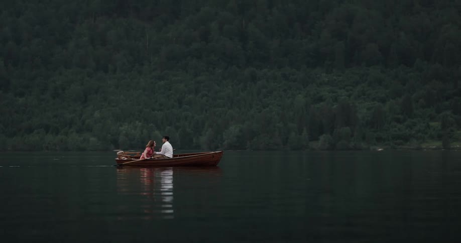 Two people are kayaking on a lake during spring