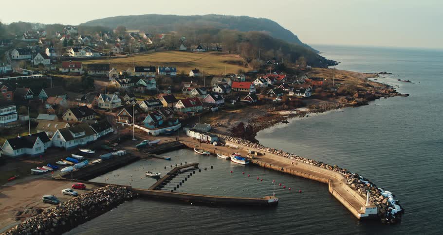 Aerial view of coastal town with pier and boats
