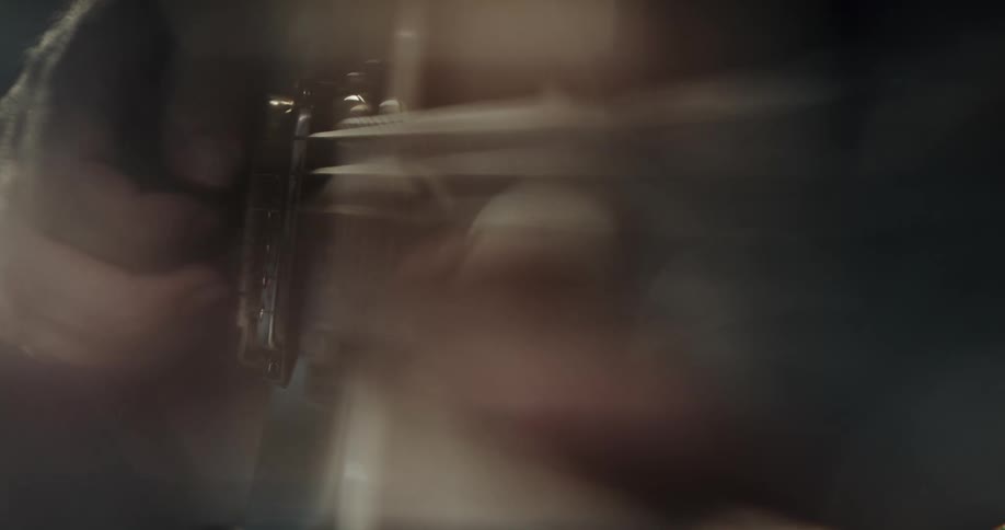 Hands playing the guitar with light and glare causing a foggy blur
