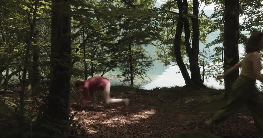 Man and woman argue in the forest as the woman shows the man a cellphone then tosses it on the ground