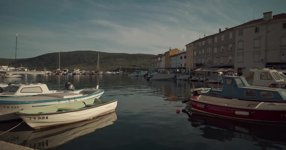 Boats are docked by the buildings