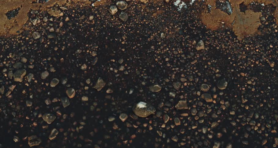 Birds eye view of rocks on soil is displayed