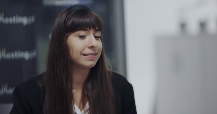 Coworkers sitting at a desk in the office having a conversation