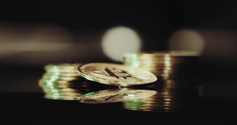 A stack of bitcoin are on the table