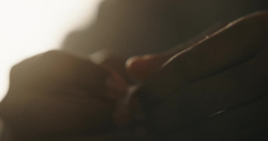Close up of a black man opening a small packet