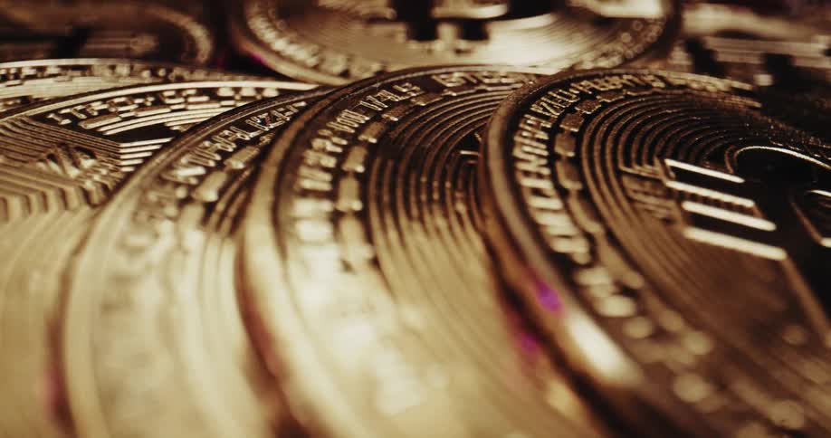 Collection of gold colored coins with an upper case b on each of them