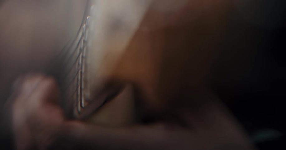 A person is playing a string instrument indoors