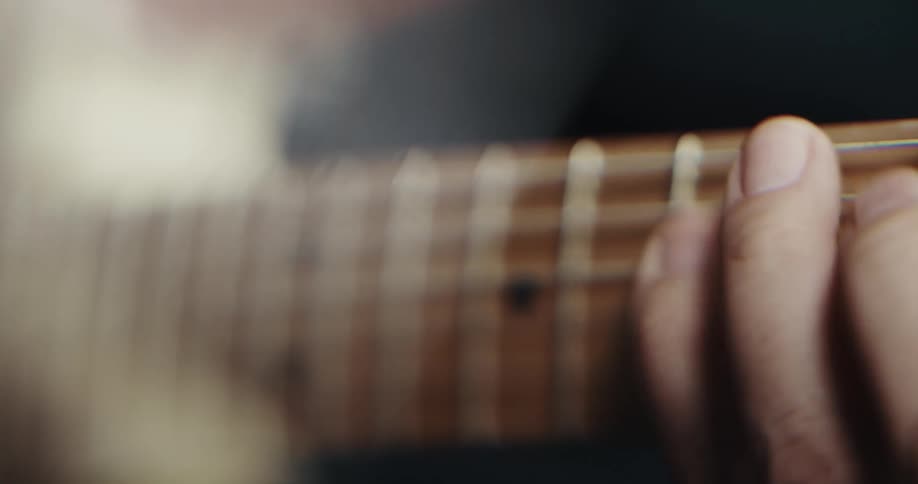A person is playing the guitar indoors