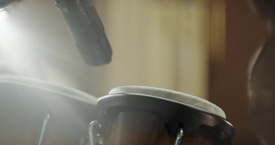 A man playing a set of drums with his hands