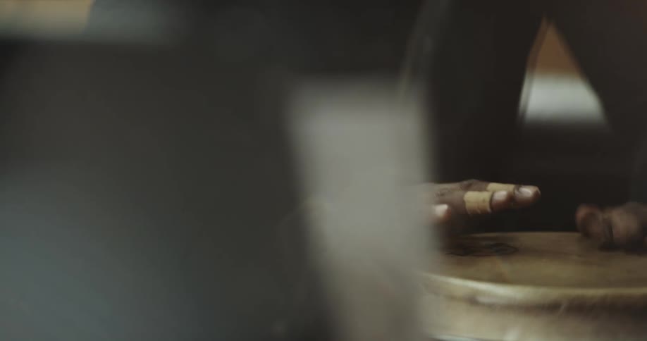 A person drumming with a hand drum