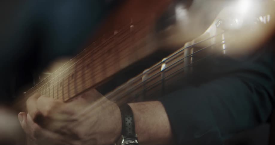 A person playing guitar indoors