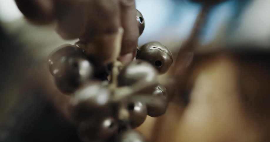 Person jingles small cluster of bells