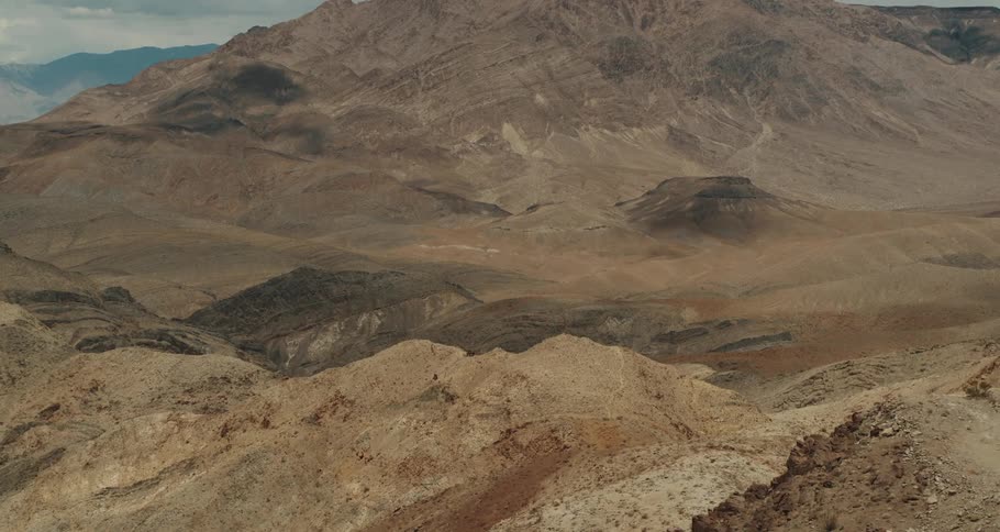 An aerial view of dirt covered mountains in nature