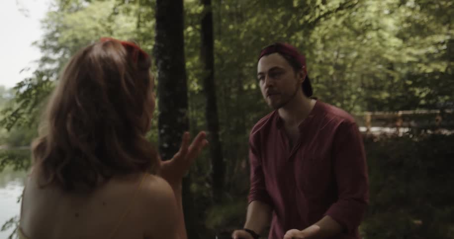 A woman shoves her partners smartphone to the ground during a fight in the woods